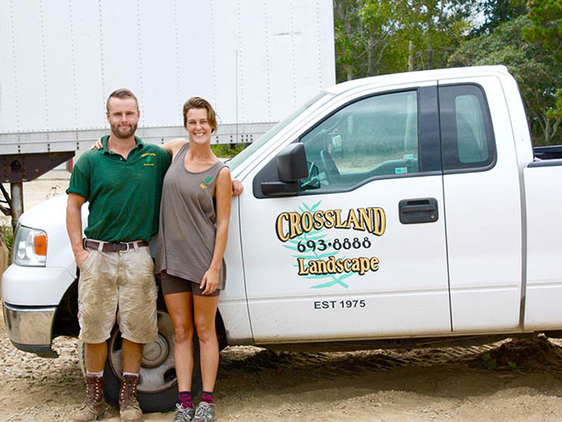 man and lady standing in front of truck